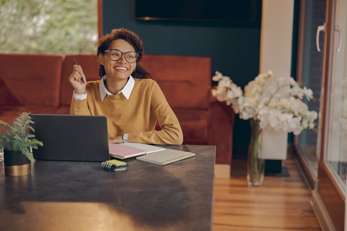 Woman working from home on a laptop – virtual workplace with cloud desktop